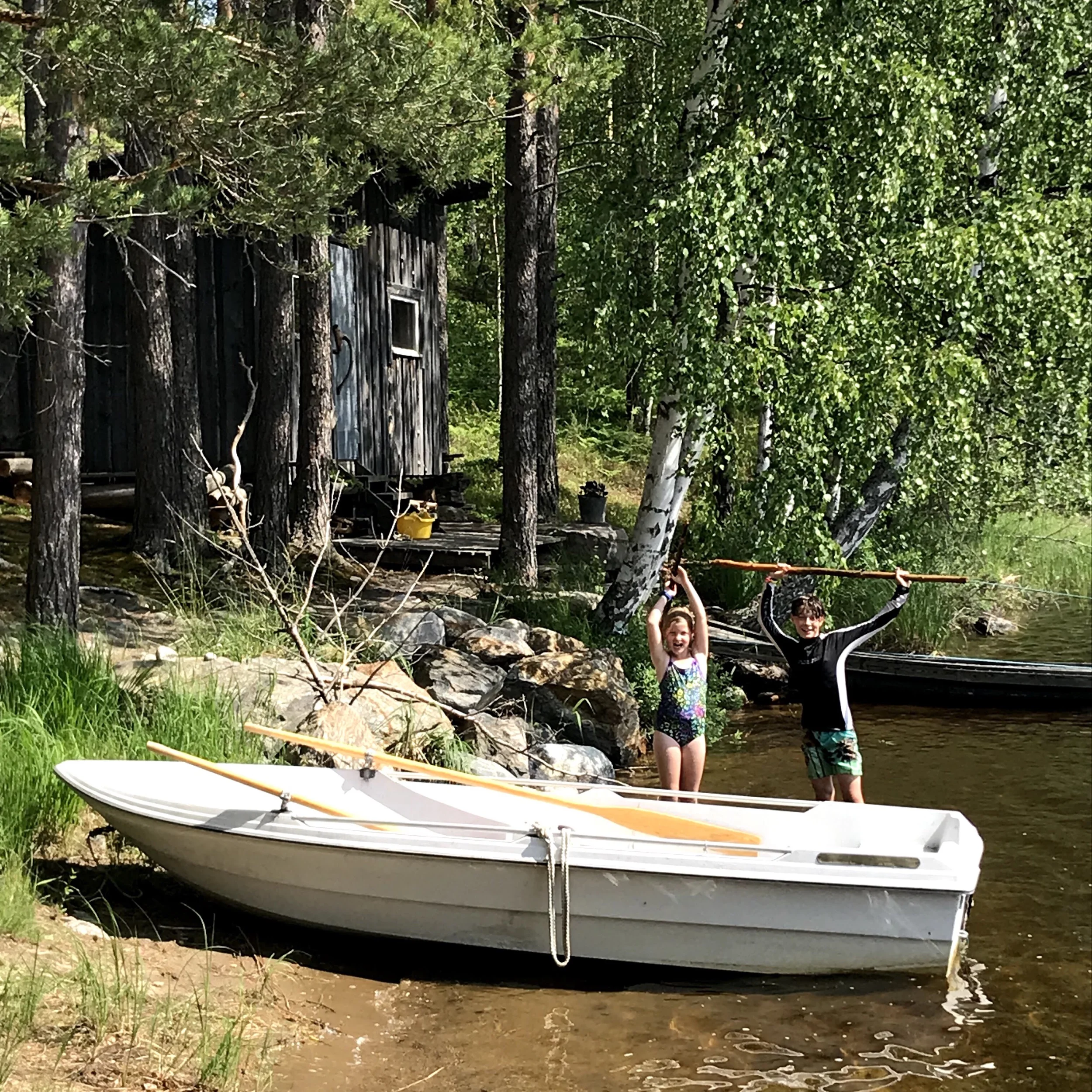 The small row boat and the sauna in the back