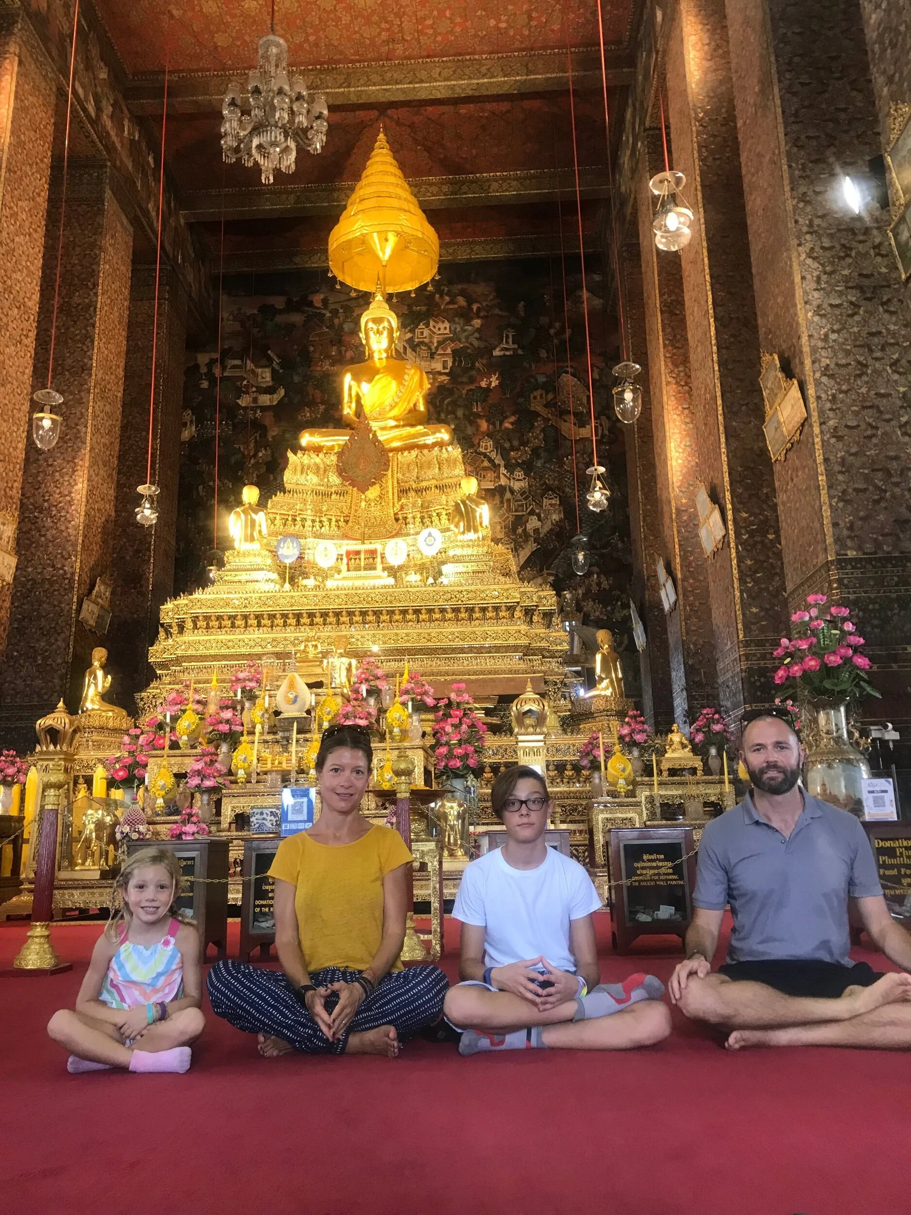 This is one of the many Buddha images that is sitting on many tall cushions and that has a umbrella that has nine “stories”.