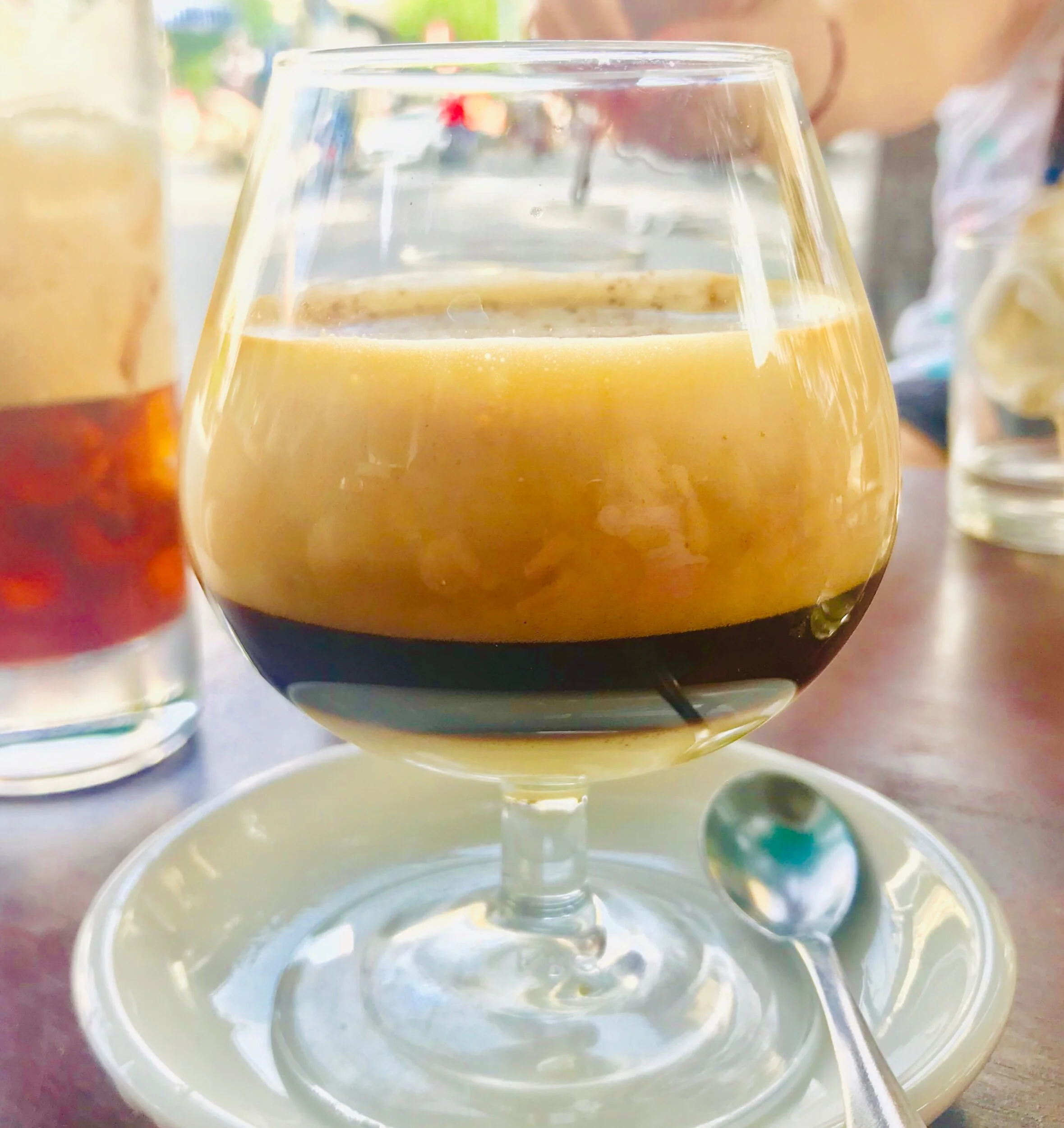 A delicious three-layered egg coffee from Hoi An, Vietnam. The bottom layer is condensed milk, then espresso in the middle, with a creamy whipped egg yolk on top. Yum!